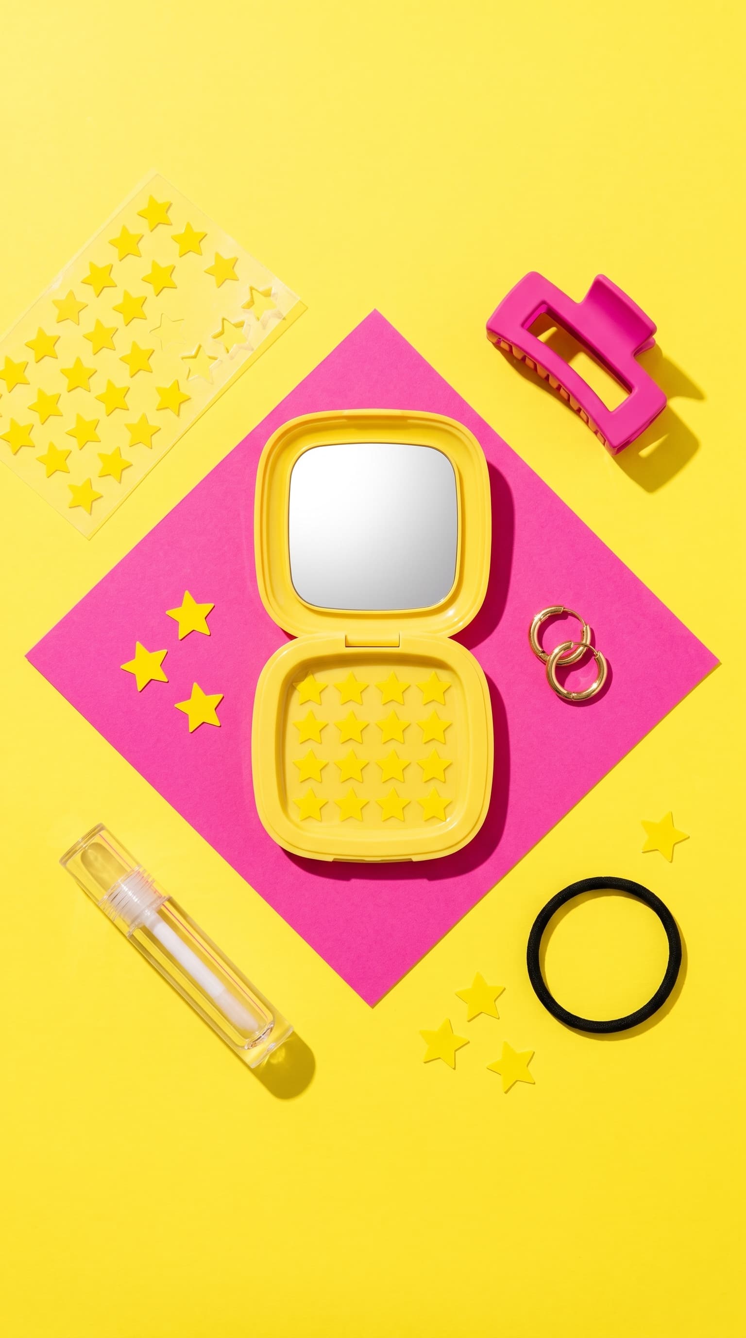 Open Starface compact with star sheets and everyday items on yellow, top-down, made with Nano Banana Pro