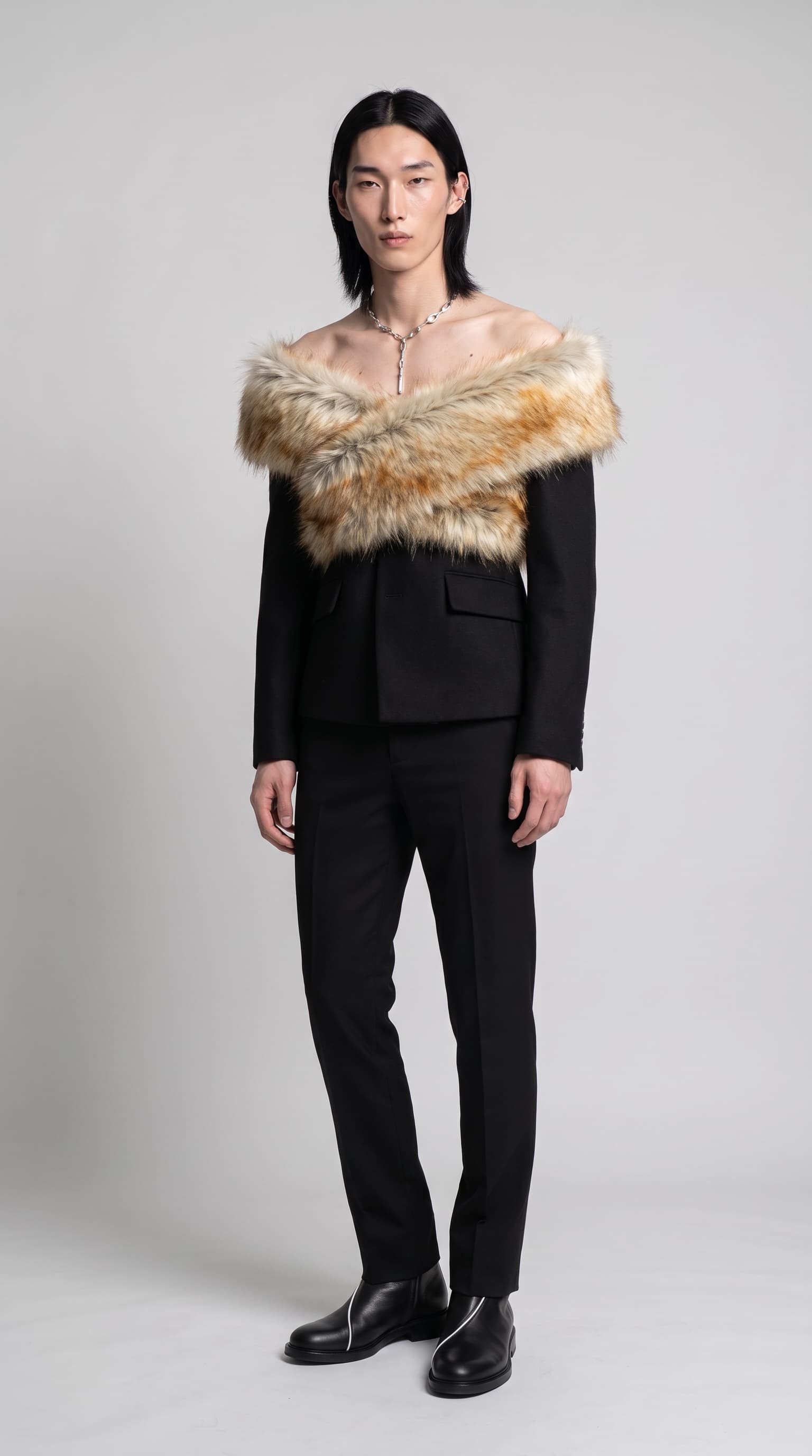 Same male model in an off-shoulder fur cowl, cropped blazer, drop necklace and piped boots, made with Nano Banana Pro