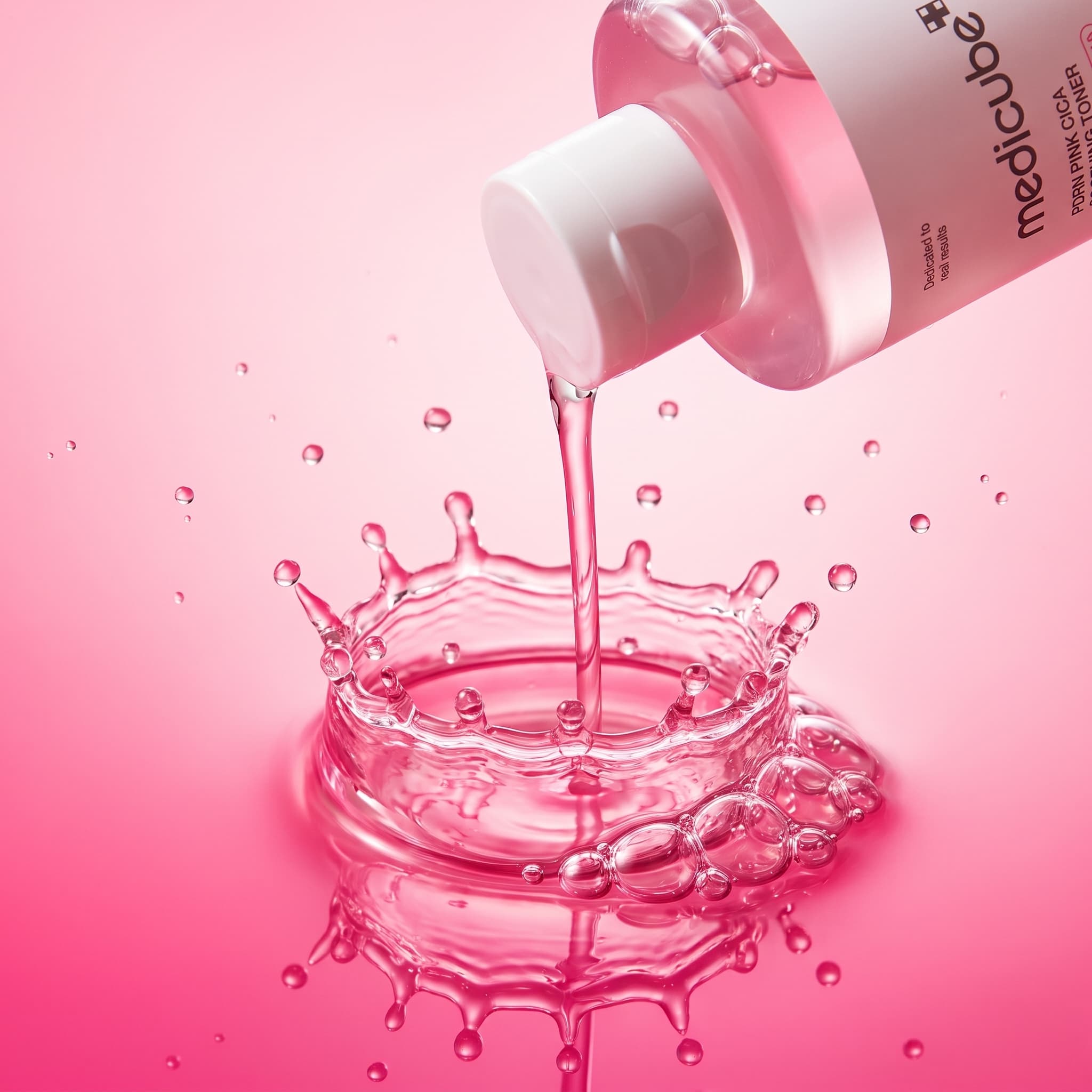 Macro of a tipped pink toner bottle pouring a stream into a crown splash on a pink surface, made with Nano Banana Pro