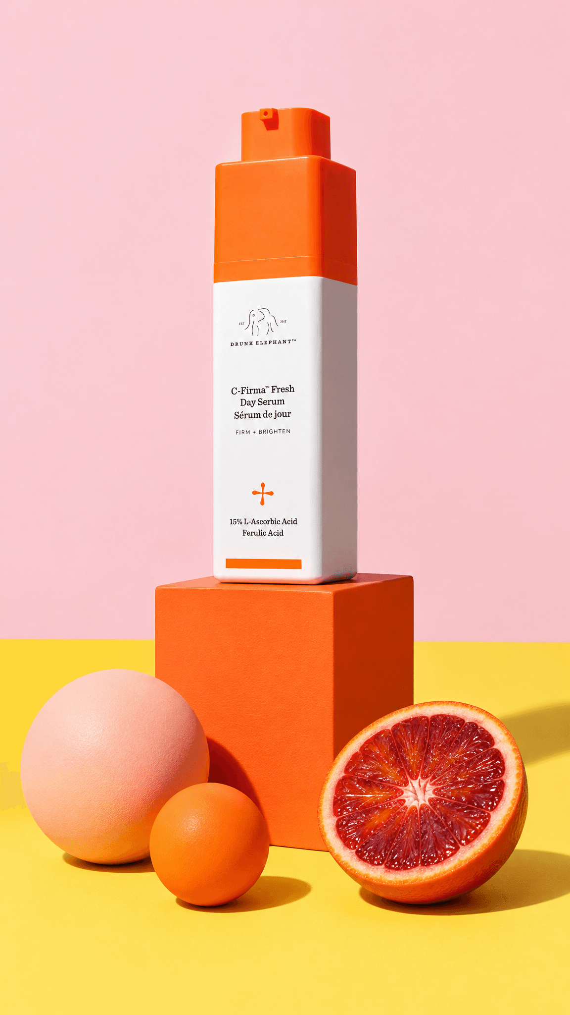Drunk Elephant C-Firma serum bottle on an orange block with spheres and a halved blood orange, made with GPT Image 2.5 Flare