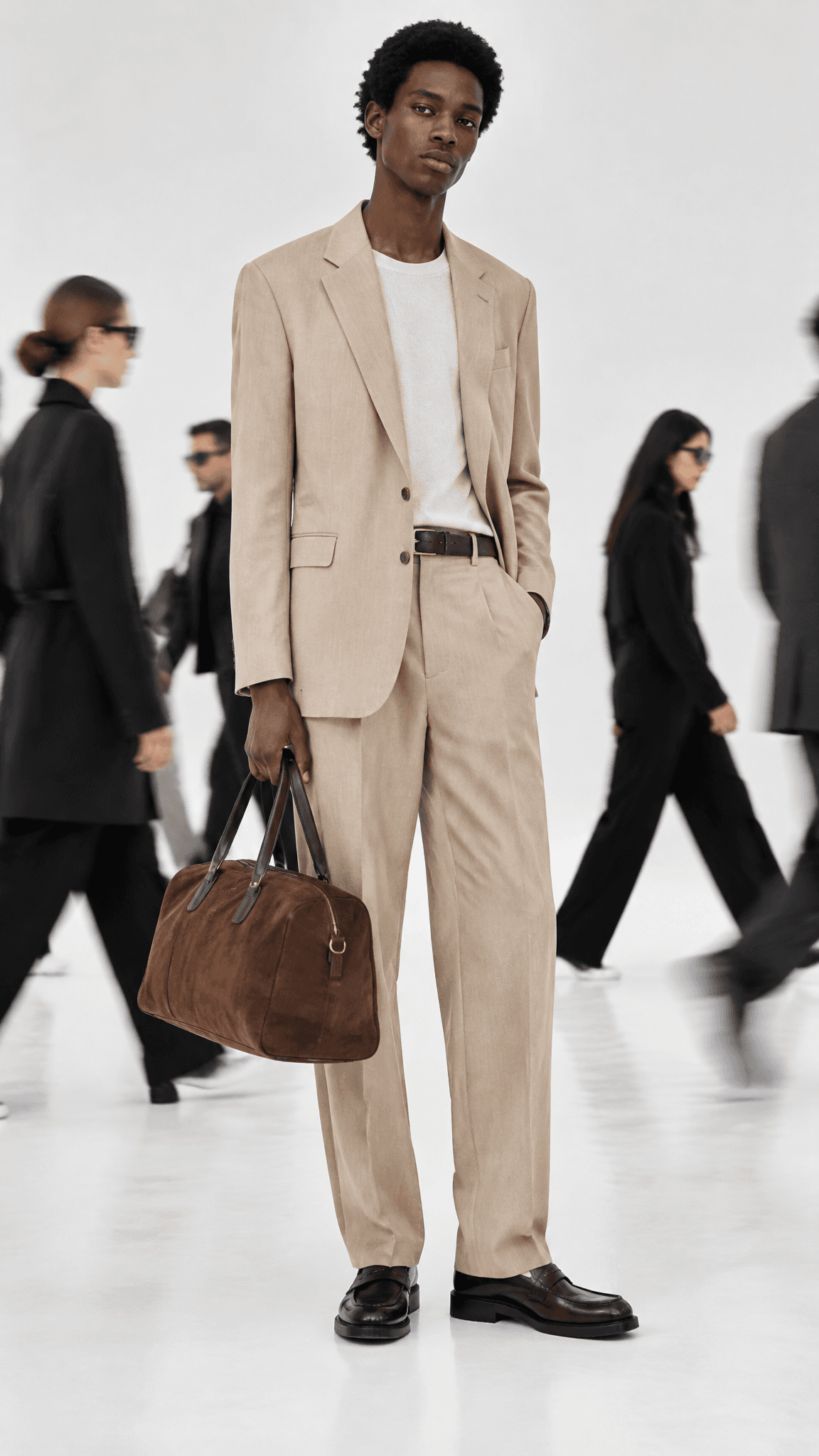 Model in a beige suit holding a suede duffel in a white void, people in black walking behind, made with GPT Image 2.5 Sunburst