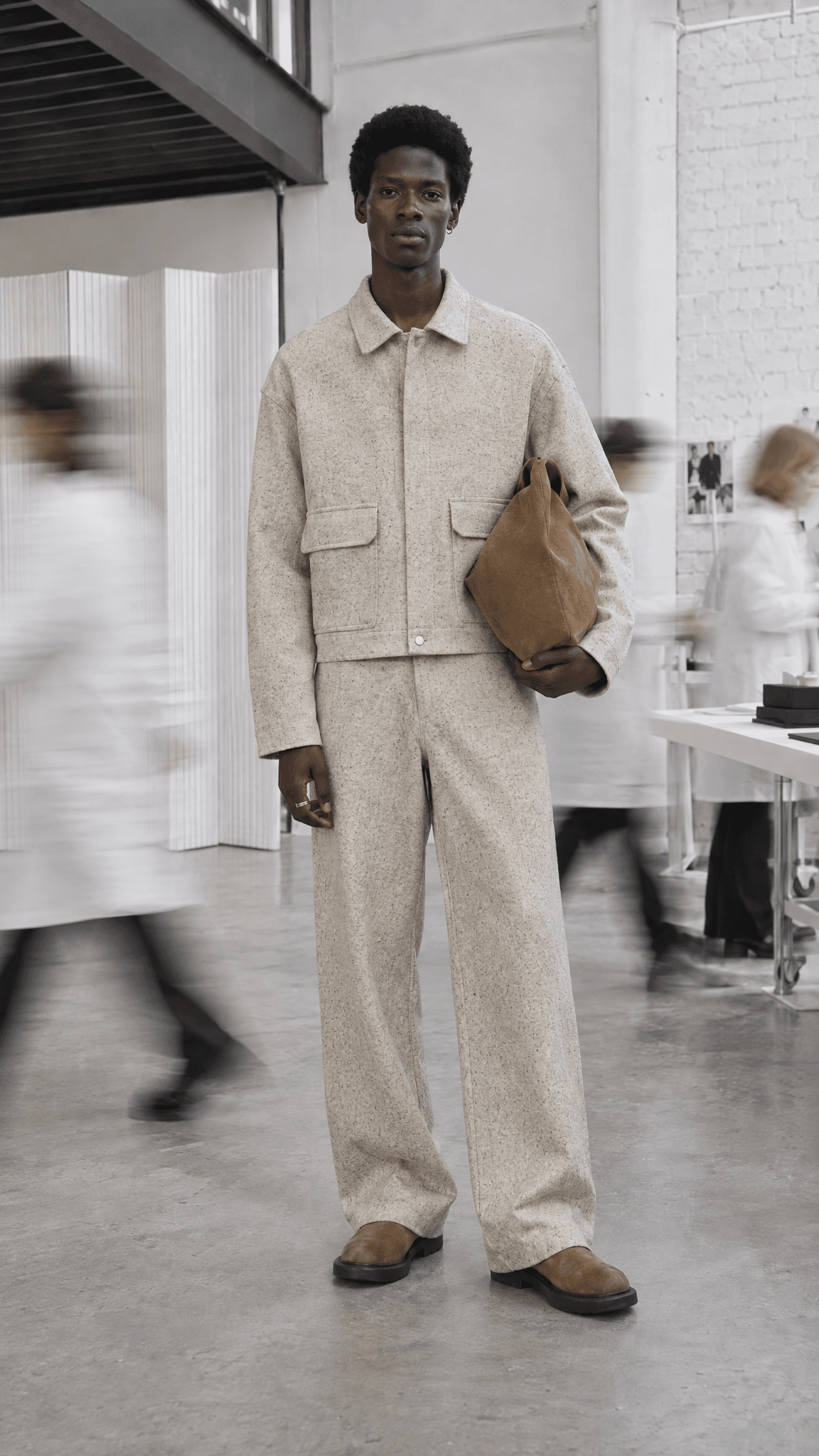 Same model in a fine oatmeal tweed suit, steel rack removed, made with GPT Image 2.5 Sunburst