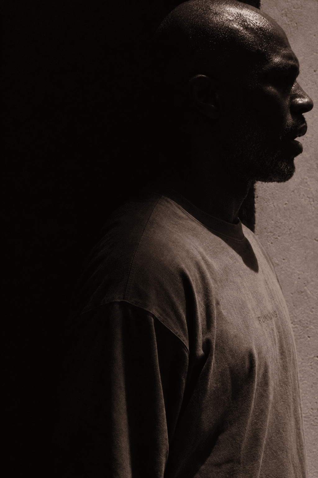 Man in profile almost fully in shadow, only his crown and nose catching light, made with GPT Image 2.5 Sunburst