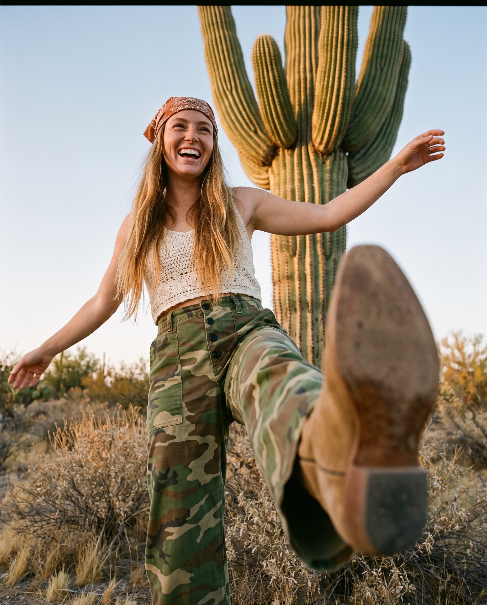 Laughing woman kicking a suede cowboy boot at the camera in front of a saguaro cactus, made with Nano Banana Pro